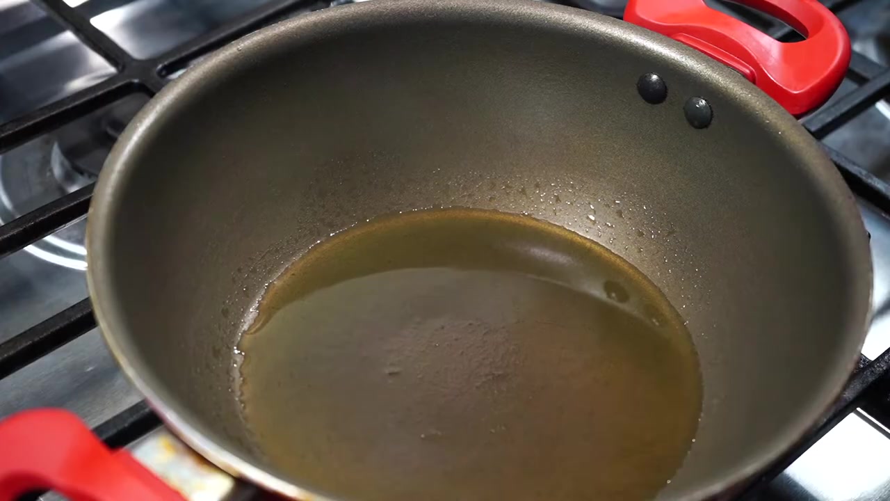 Peanuts gently frying in oil and ghee in a pan