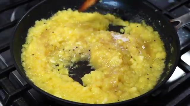 Pineapple chutney simmering with sugar and mustard seeds