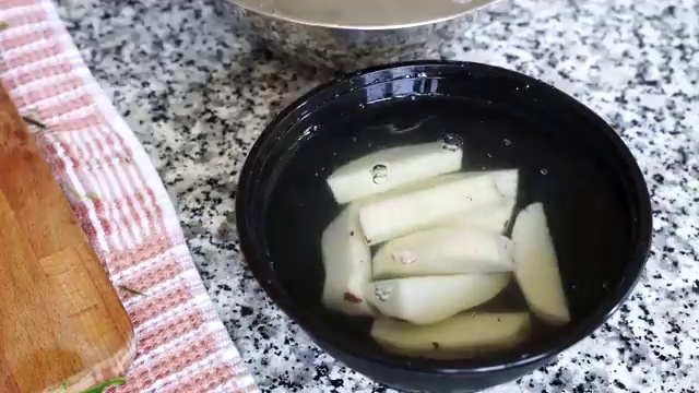 Peeled potato cubes frying in hot cooking oil until golden brown on all sides