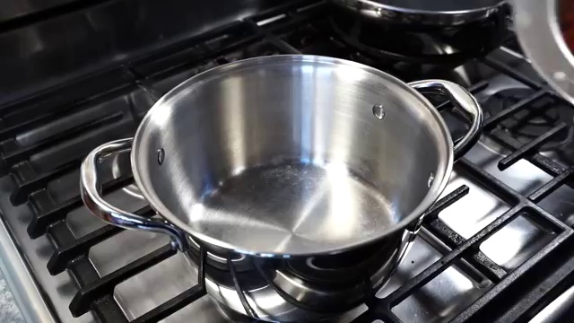 Red lentils gently simmering in a partially covered pot on the stovetop