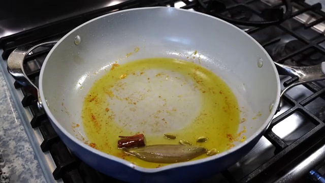 Aromatic red ground spice slurry added to the sautéed onion base