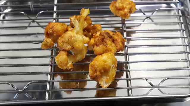 Roughly chopped fresh garlic cloves frying gently in foaming butter and oil