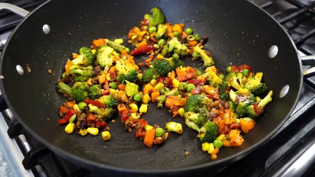 A drizzle of oil and light salt added over the cold rice grains in the pan
