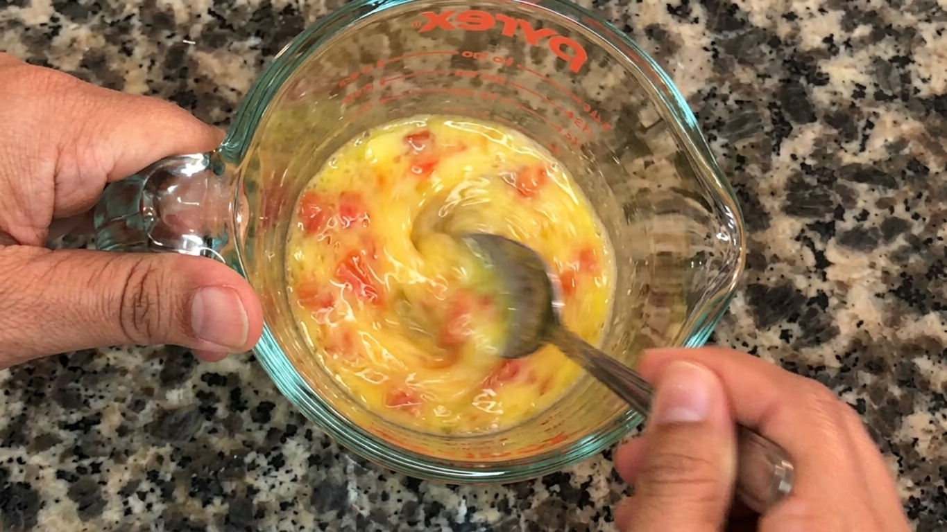 Seasoned egg mixture poured into a lightly oiled non-stick frying pan
