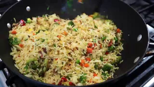 Vegetable masala rice served in a bowl with cool cucumber raita and fresh salad