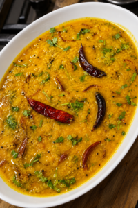 Simple Bengali Style Masoor Dal - Golden silky red lentil dal garnished with caramelized browned onions and fresh coriander
