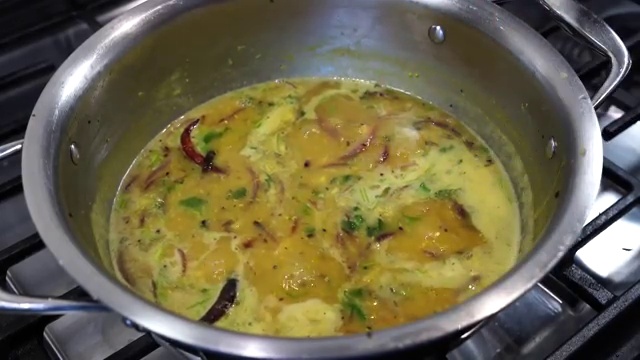 Bengali masoor dal served traditionally in a bowl with steamed white rice and crispy onions