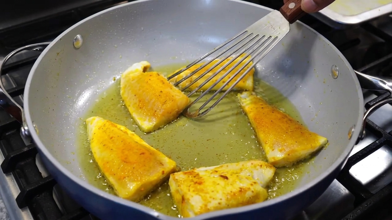 Thinly sliced yellow onions added to the tempered whole spices in the pan