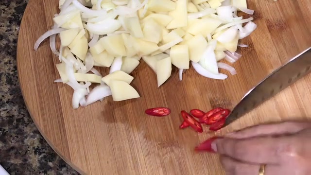 Sliced potatoes and onions mixed together and ready to be cooked