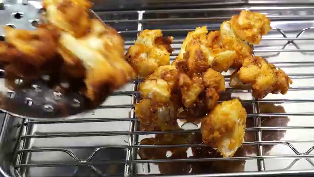 Fresh cauliflower cut into small bite-sized florets ready for blanching