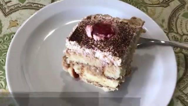 Smooth layer of whipped cream spread evenly across the top of the coffee trifle
