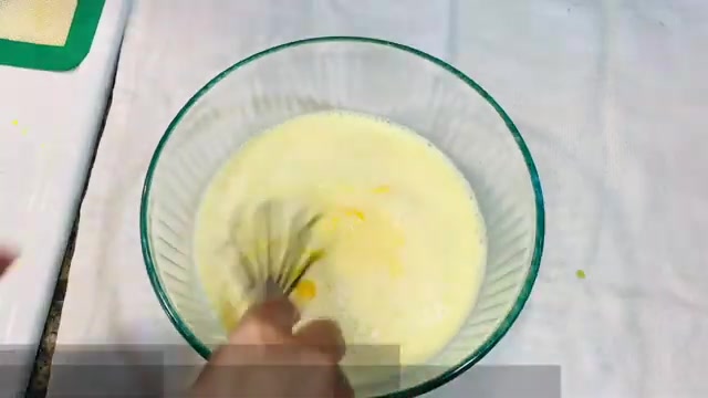 Smooth mango puree being mixed into the custard base
