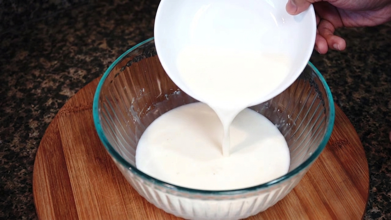 Smooth milk, cornstarch, and cream mixture being whisked together