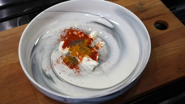 Smooth, thick, and vibrant red tandoori yogurt marinade whisked and ready for fish
