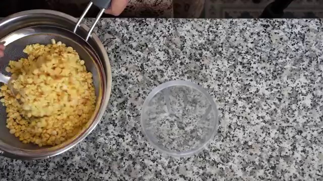 Silky smooth yellow moong dal chilla batter freshly blended and resting in a bowl