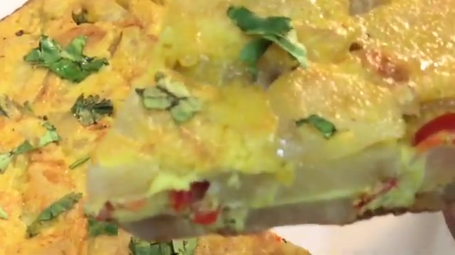Spicy Indian-style potato omelette with sliced green and red chilies