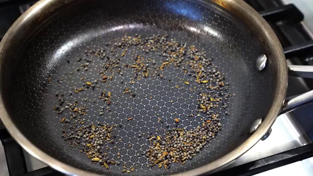 Freshly ground roasted mustard and panch phoron spice powder sprinkled over the finished fish curry