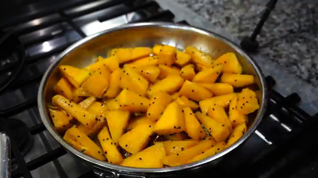 Cauliflower florets and potato cubes thoroughly stirred and coated in the spiced masala