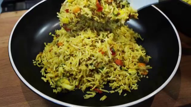 Leftover vegetable masala rice stored in an airtight glass meal-prep container