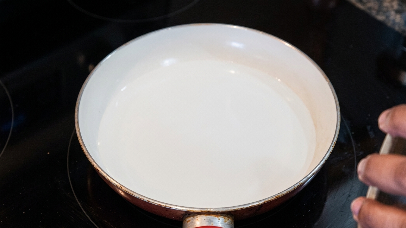 Sugar, water, lemon juice, and hot water prepared for making caramel
