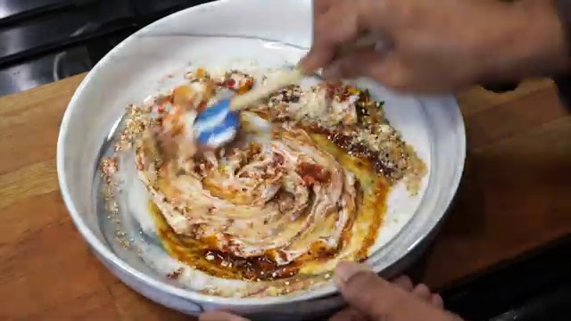 Tandoori salmon fillets cooking and sizzling inside the air fryer basket