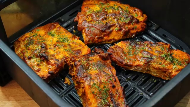 Tandoori fish roasting in the oven with lightly browned charred edges