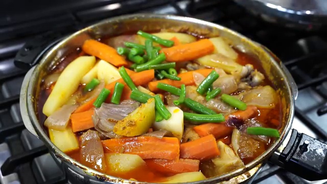 Tender cooked chicken and fork-tender vegetables resting in the golden, fragrant broth