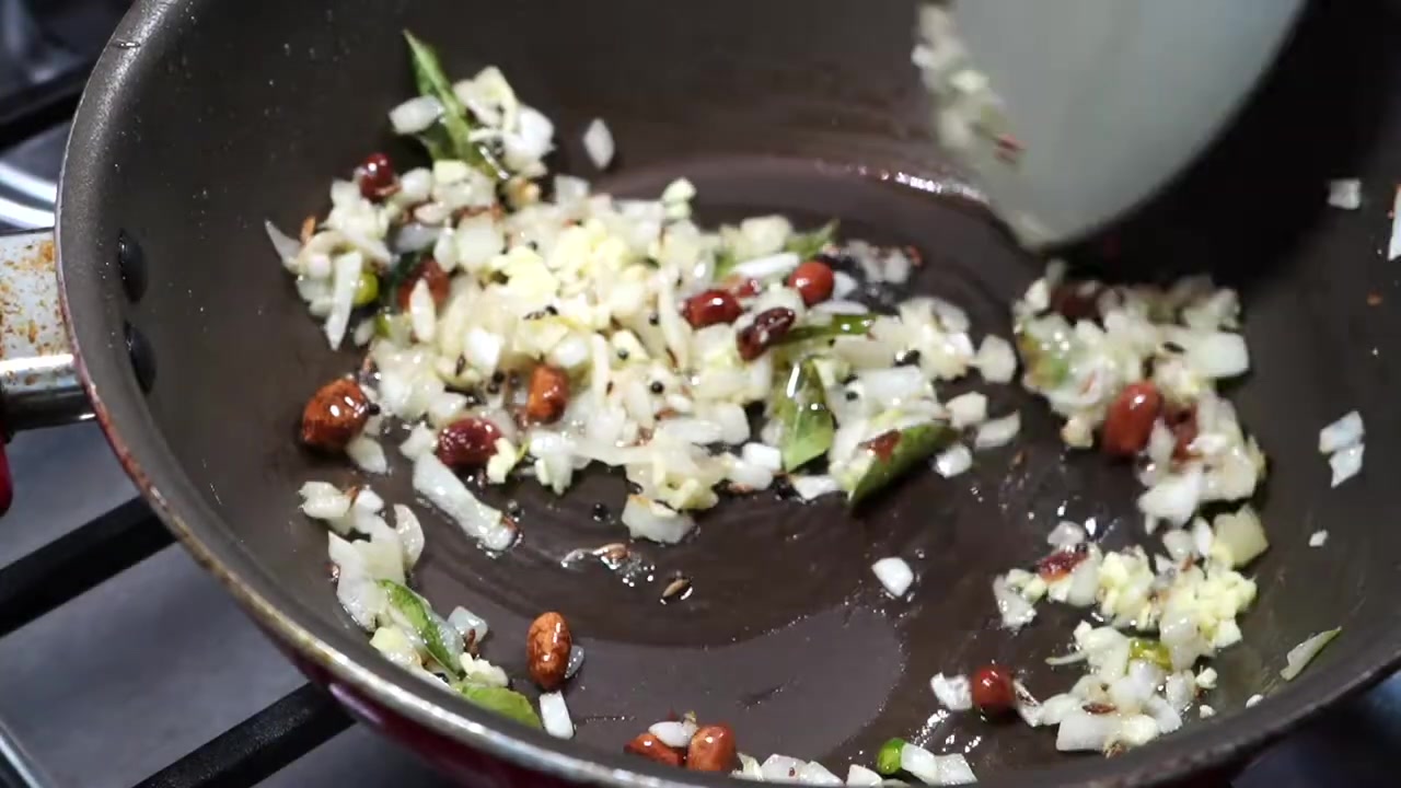 Thawed and drained frozen mixed vegetables with chopped onion, ginger, and green chili prepared for cooking