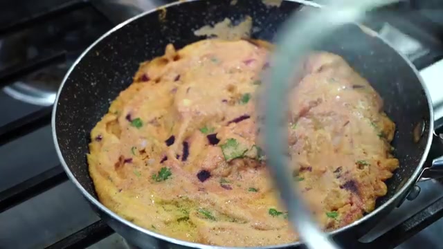 Thick moonglet batter spread into a round pancake in a non-stick pan