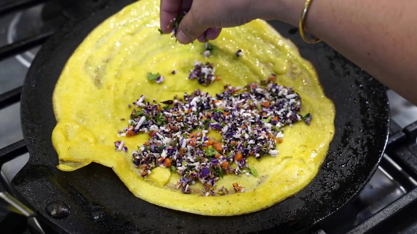 Thin and crackly crispy moong dal chilla cooked to golden-brown perfection