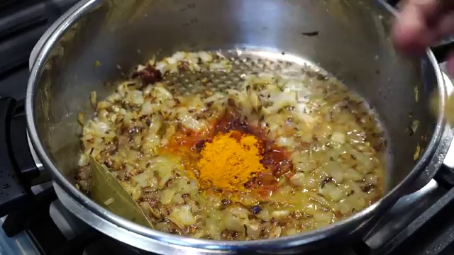 Tomato and onion masala cooking down into a thick, glossy, aromatic curry paste