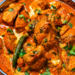 Ultimate Butter Chicken (Murgh Makhani) - Succulent roasted chicken pieces simmered in a rich, velvety tomato and butter gravy garnished with fresh cream and coriander