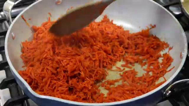 Fresh whole milk being poured into the carrot and condensed milk mixture