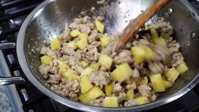 Smooth spiced yogurt mixture poured directly over the chicken keema and potatoes